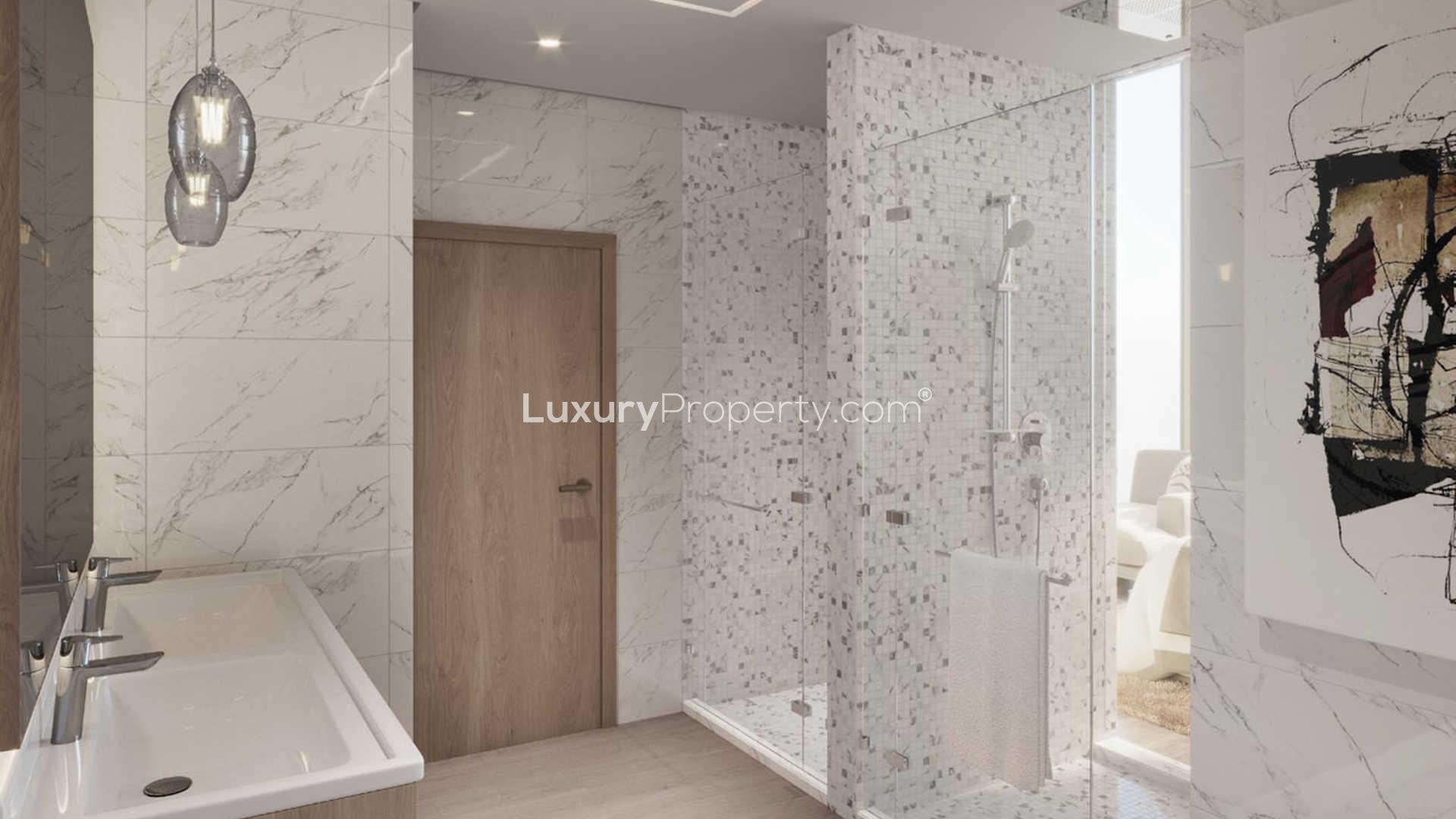 Luxurious Dubai Marina penthouse living room with city skyline views at sunset