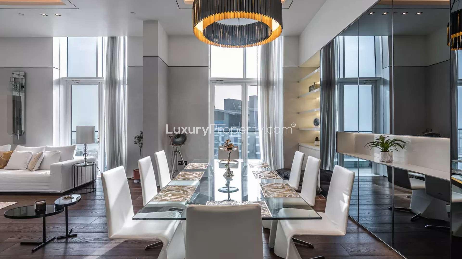 Modern furnished living room in Palm Jumeirah penthouse, featuring elegant decor and natural light