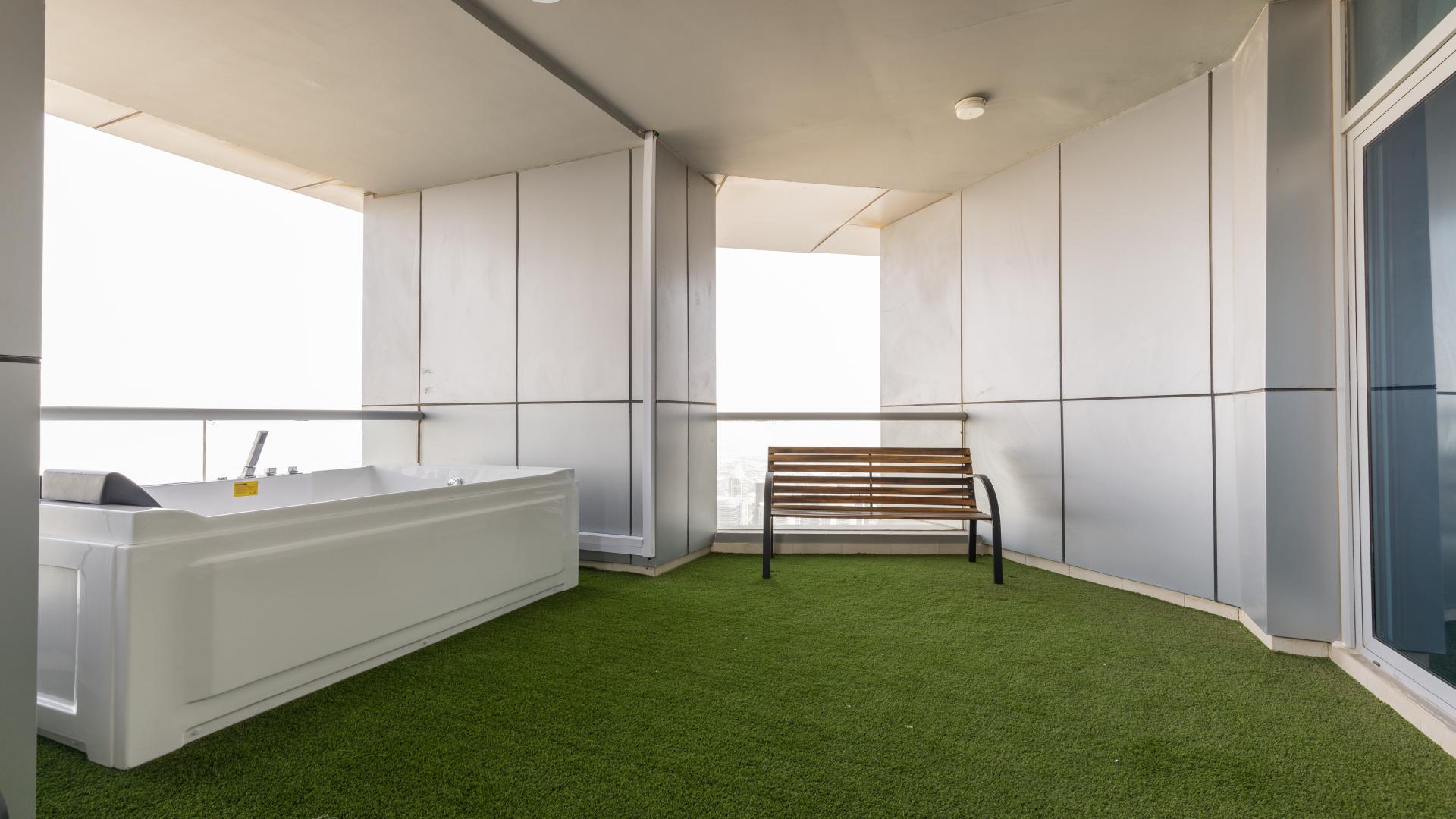 Penthouse terrace with stunning Dubai Marina view, featuring modern outdoor seating area