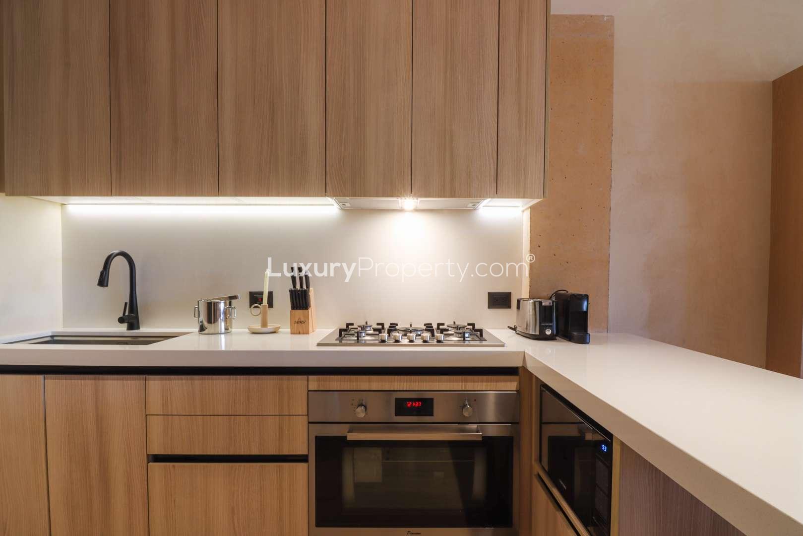 Modern kitchen with sleek countertops and gas stove in Corasol Riviera Maya penthouse