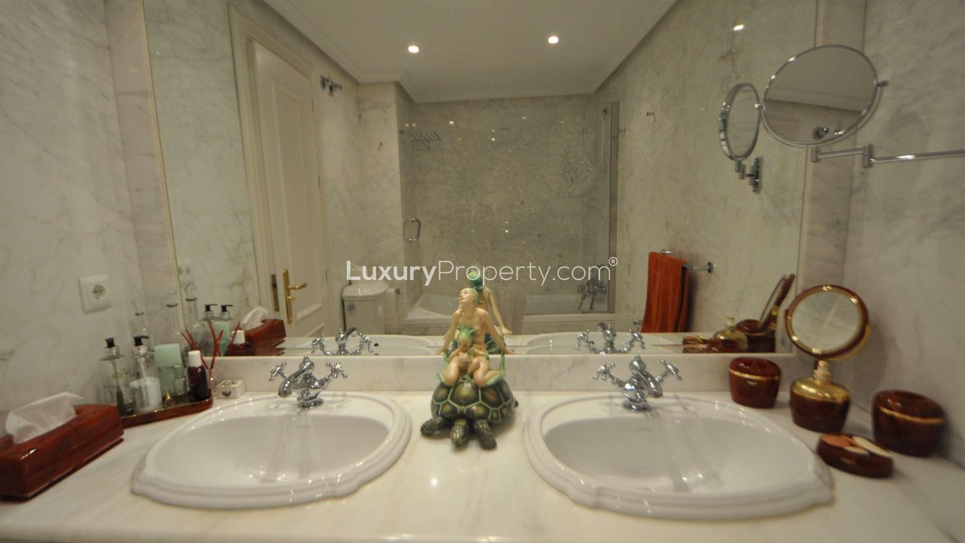 Luxurious marble bathroom in Torremolinos penthouse with dual sinks and elegant decor