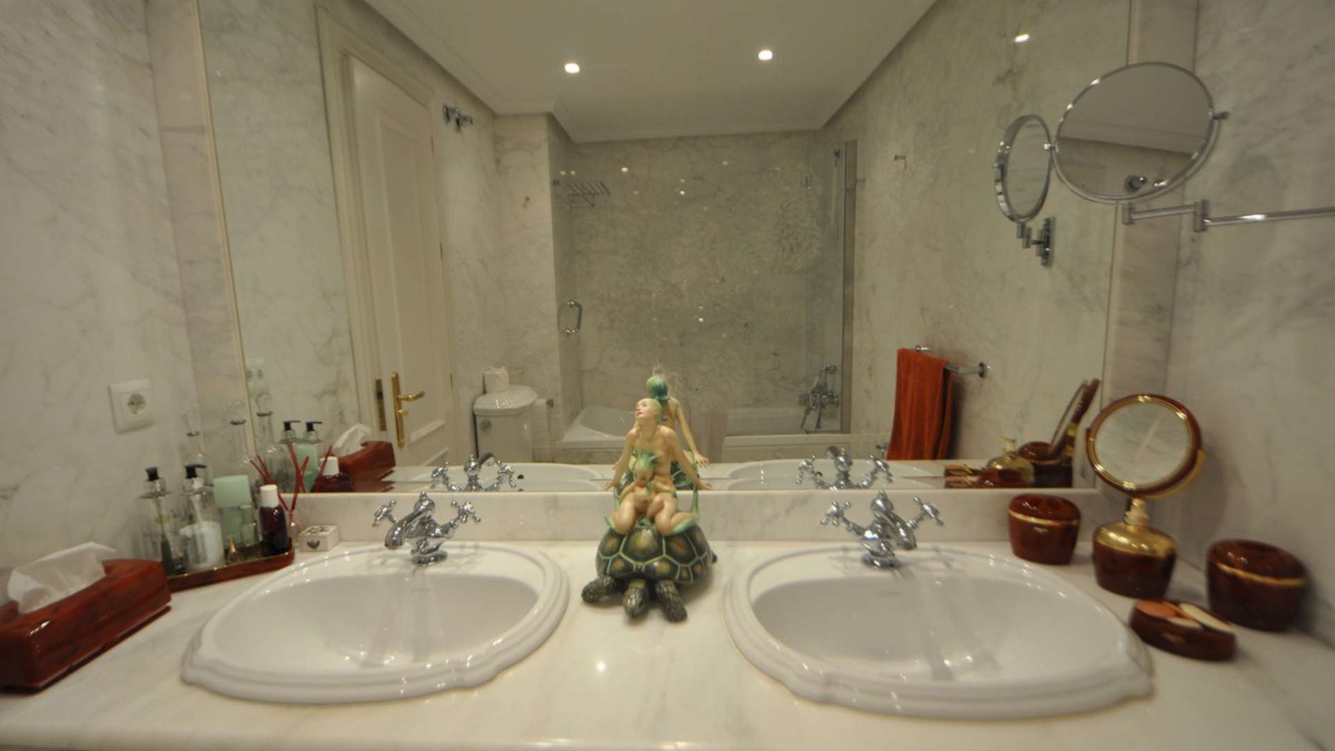 Luxurious marble bathroom in Torremolinos penthouse with dual sinks and elegant decor