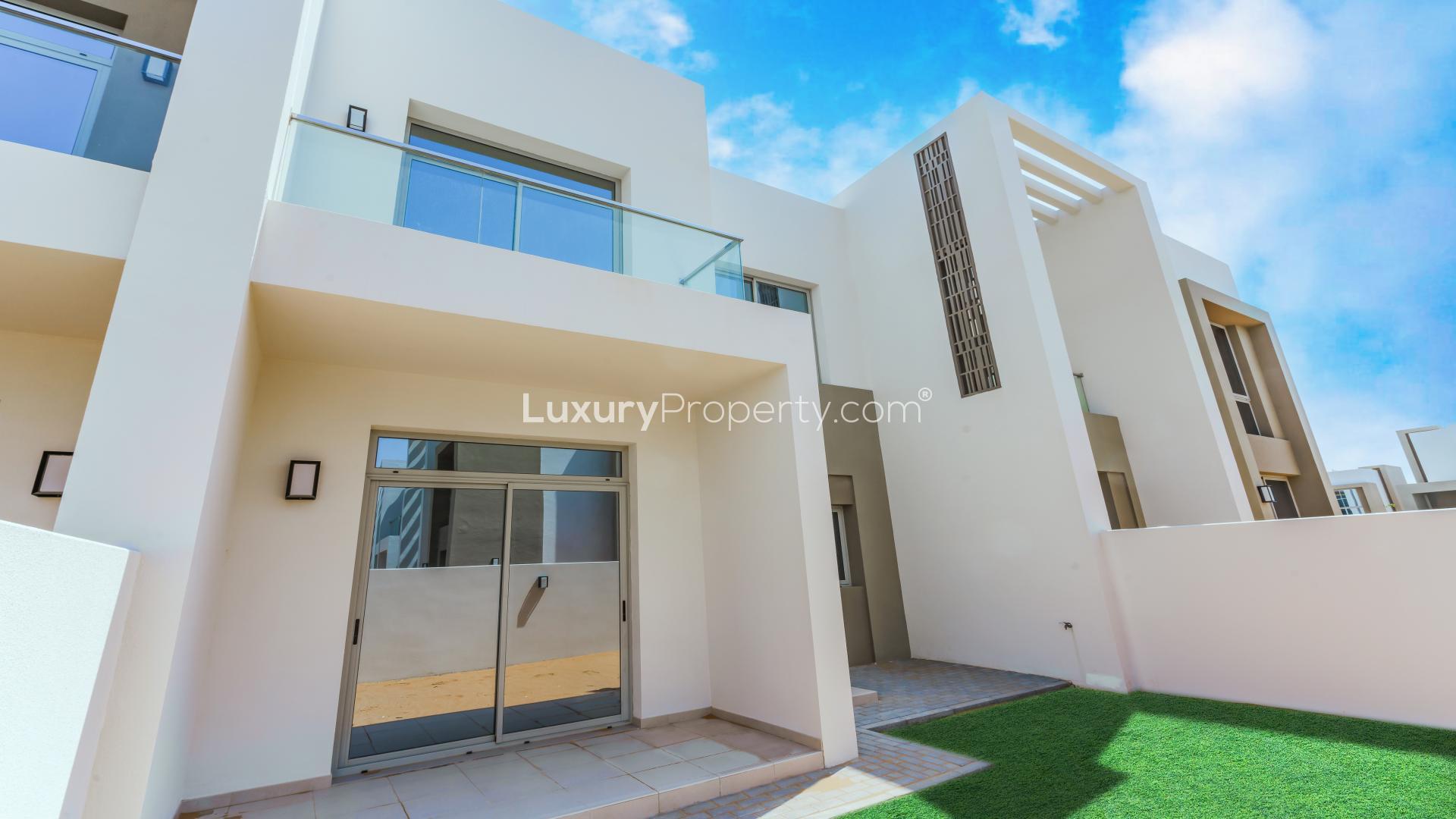 Modern kitchen and living area in Reem Community townhouse, Arabian Ranches 2, for sale