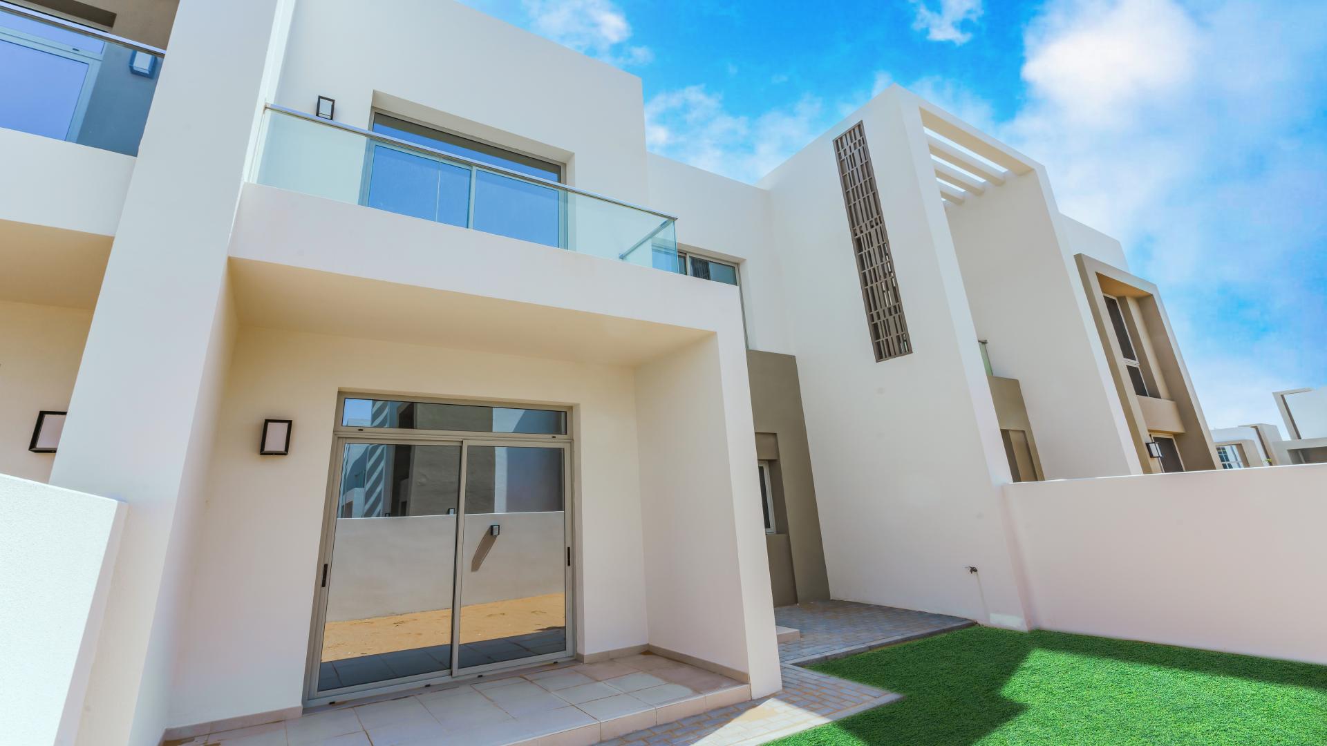 Modern kitchen and living area in Reem Community townhouse, Arabian Ranches 2, for sale