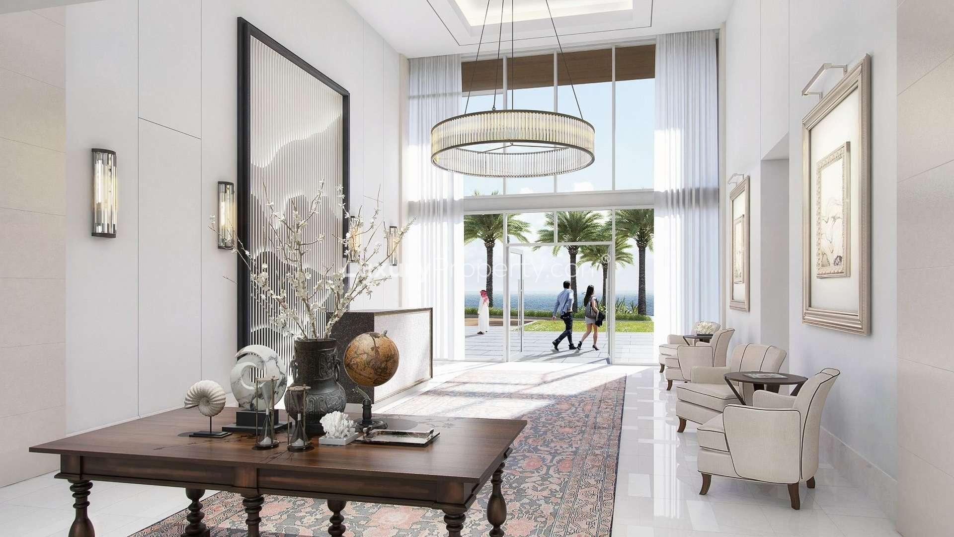 "Exquisite 3-bedroom serviced residence at The Address Fujairah with waterfront views and palm trees.",Luxurious lobby at The Address Fujairah serviced residence, featuring elegant decor and sea view