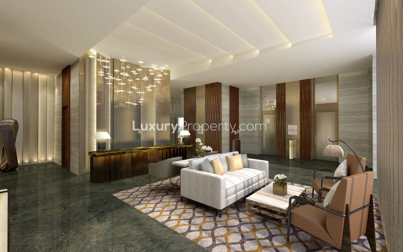 Luxurious lobby at The Ritz Carlton Residences, Kuala Lumpur, featuring elegant chandeliers and fountain