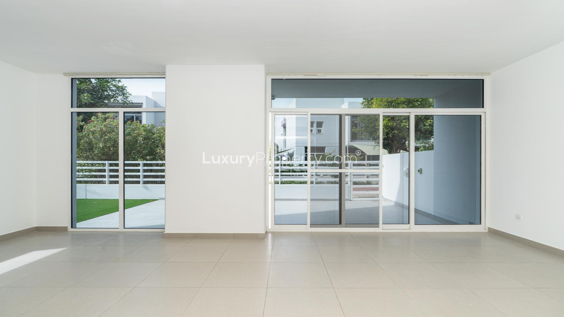 "Spacious patio with green yard in upgraded Mudon Arabella Townhouse for rent.",Modern townhouse interior with large windows, Arabella Townhouses 2, Mudon