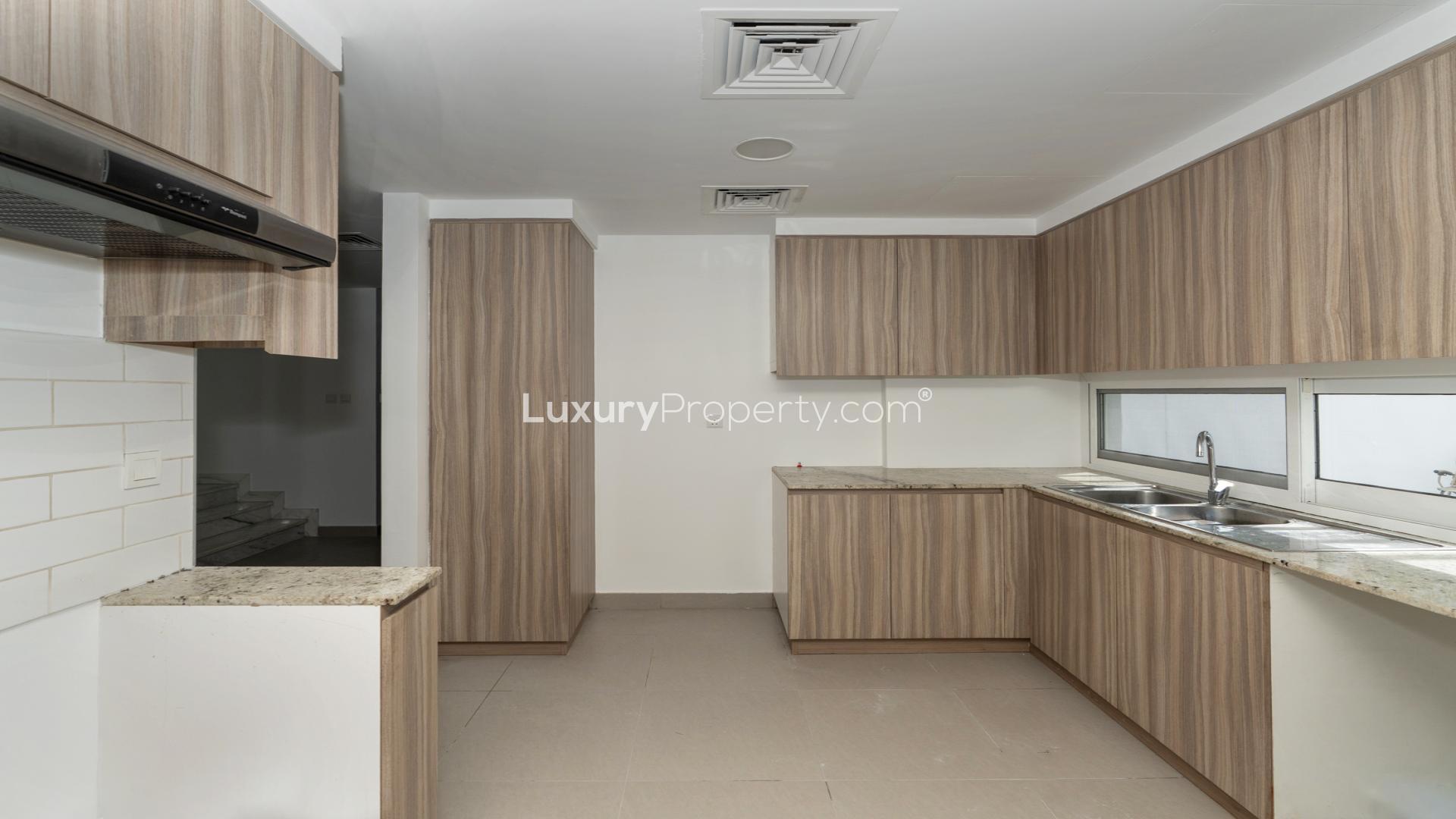 Modern kitchen in upgraded 3-bedroom townhouse, Arabella Townhouses 2, Mudon, for rent