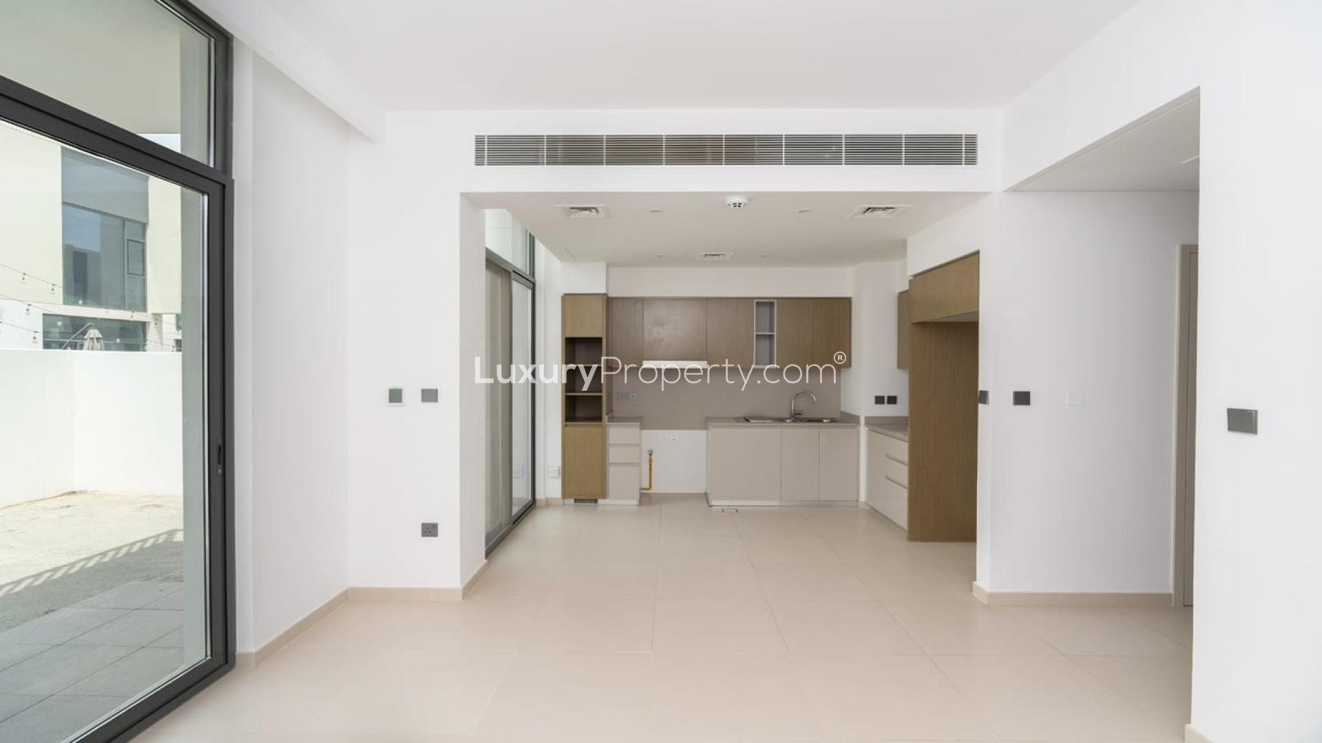 Modern living room with large windows in Joy Arabian Ranches 3 townhouse for rent