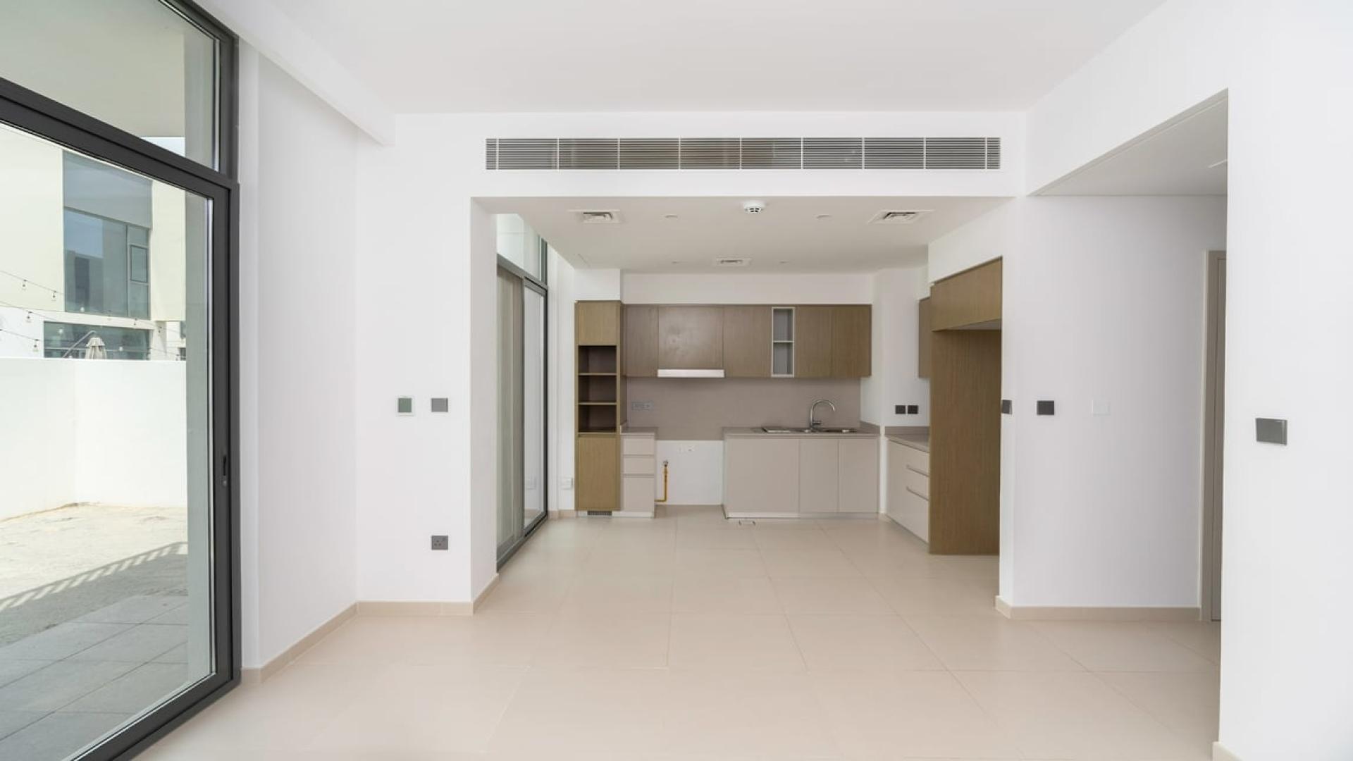 Modern living room with large windows in Joy Arabian Ranches 3 townhouse for rent