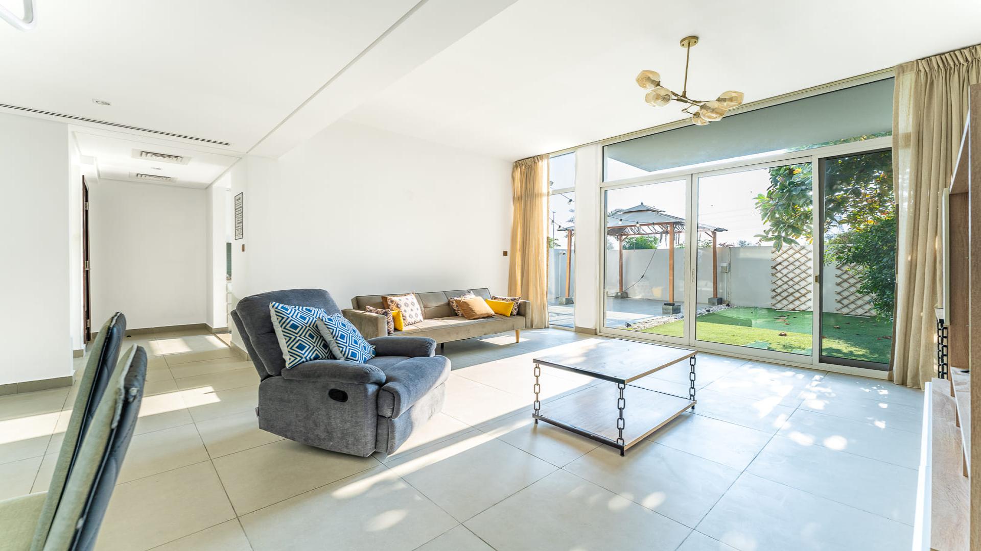 Outdoor patio and garden area in Arabella Townhouses, Mudon, available for rent