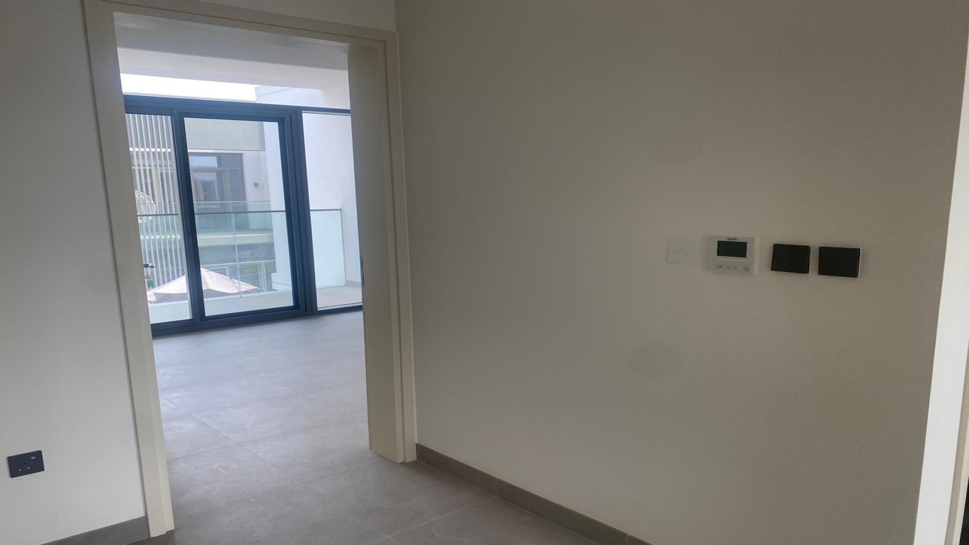 Modern living room with large windows in Ruba townhouse, Arabian Ranches 3