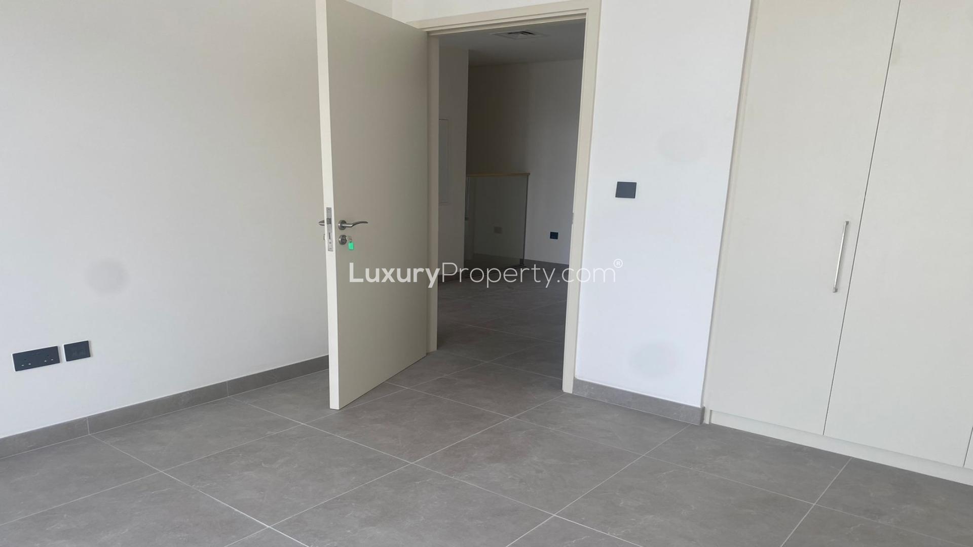 Modern kitchen and living area in Ruba townhouse, Arabian Ranches 3, with large windows