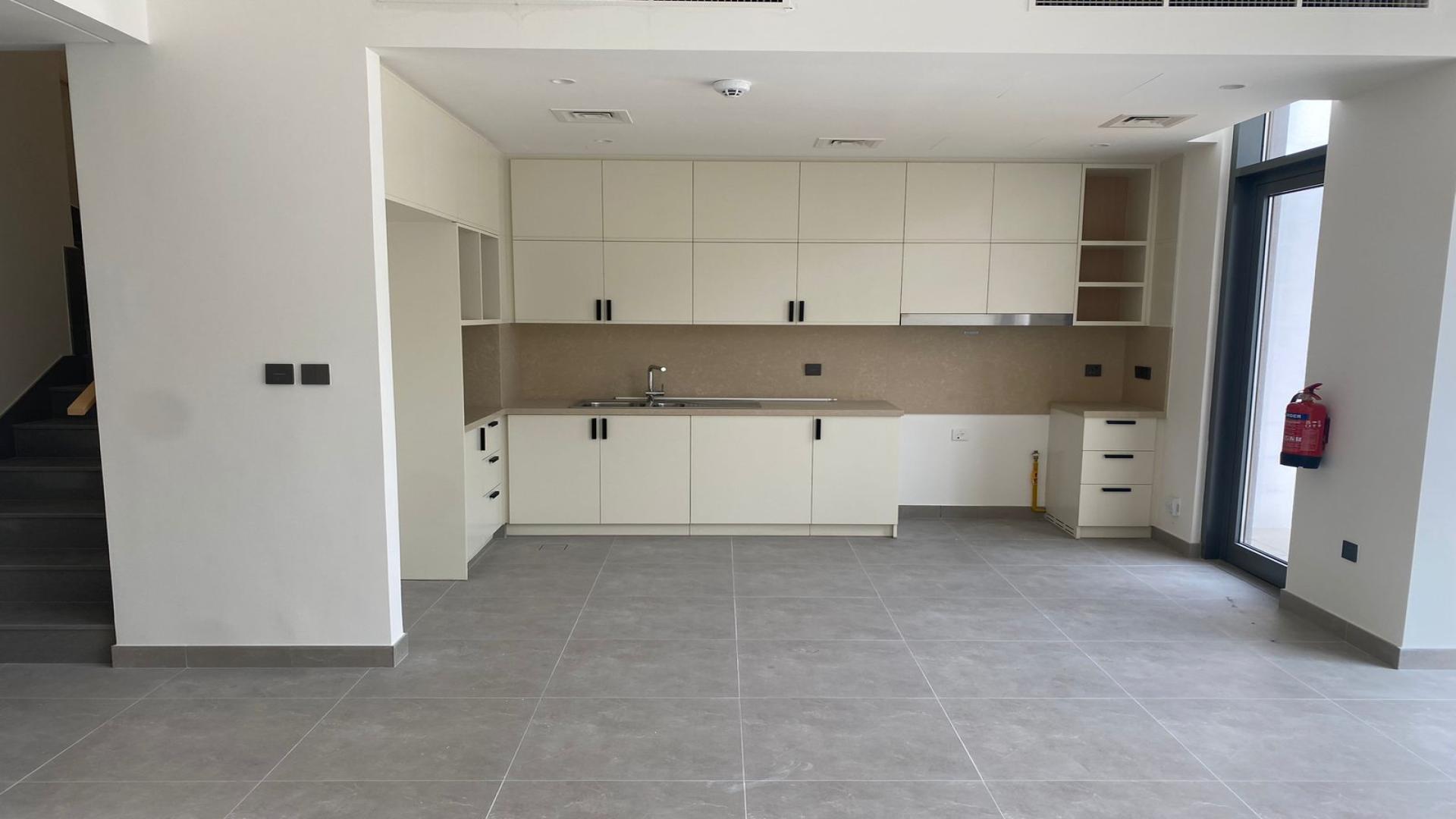 Modern kitchen area in 3-bed villa, Bliss, Arabian Ranches 3, with large windows