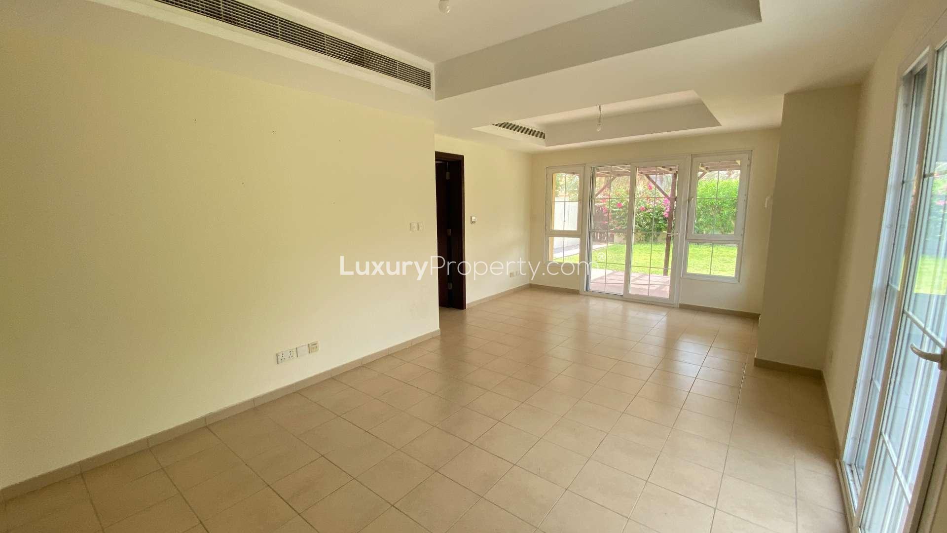 Bright living room in 3-bedroom villa, Al Reem 3, Arabian Ranches, with garden view.