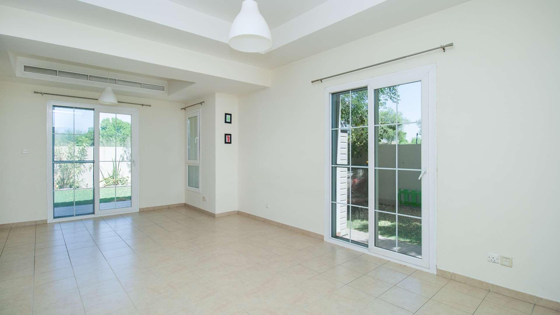 "Spacious backyard of Type 3E townhouse in Al Reem, Arabian Ranches for rent.",Spacious living room in Type 3E townhouse, Al Reem, Arabian Ranches, large windows, tiled floor