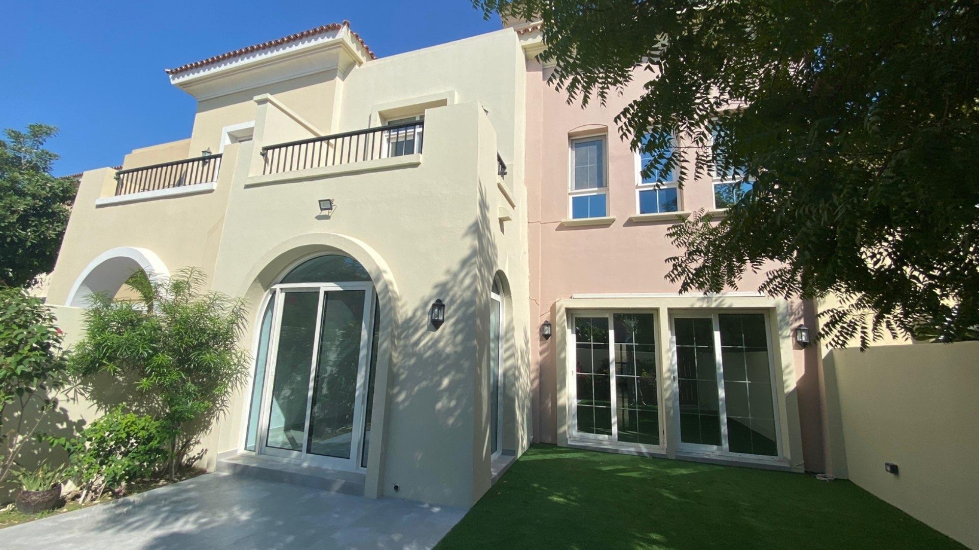 Modern townhouse exterior with garden in Al Reem