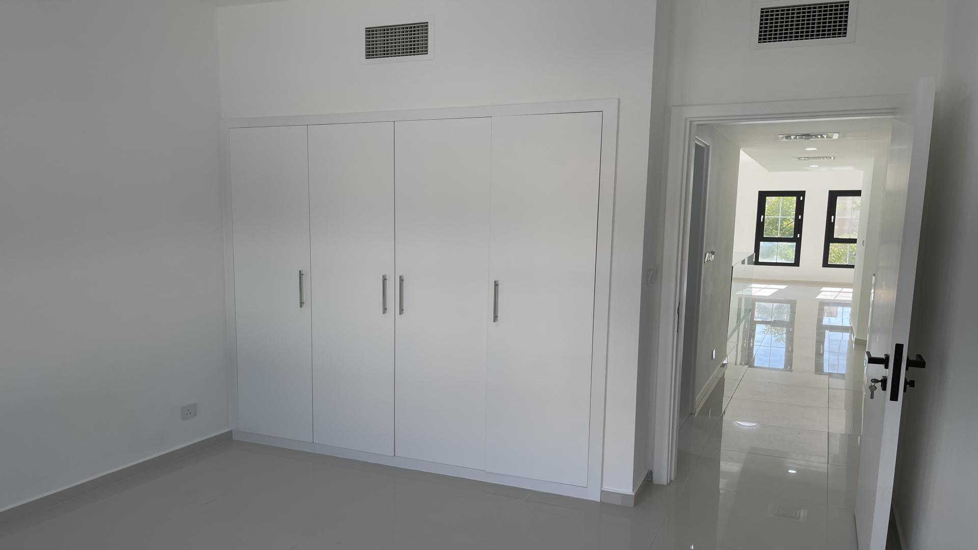 Modern townhouse exterior with garden in Al Reem, Arabian Ranches for rent