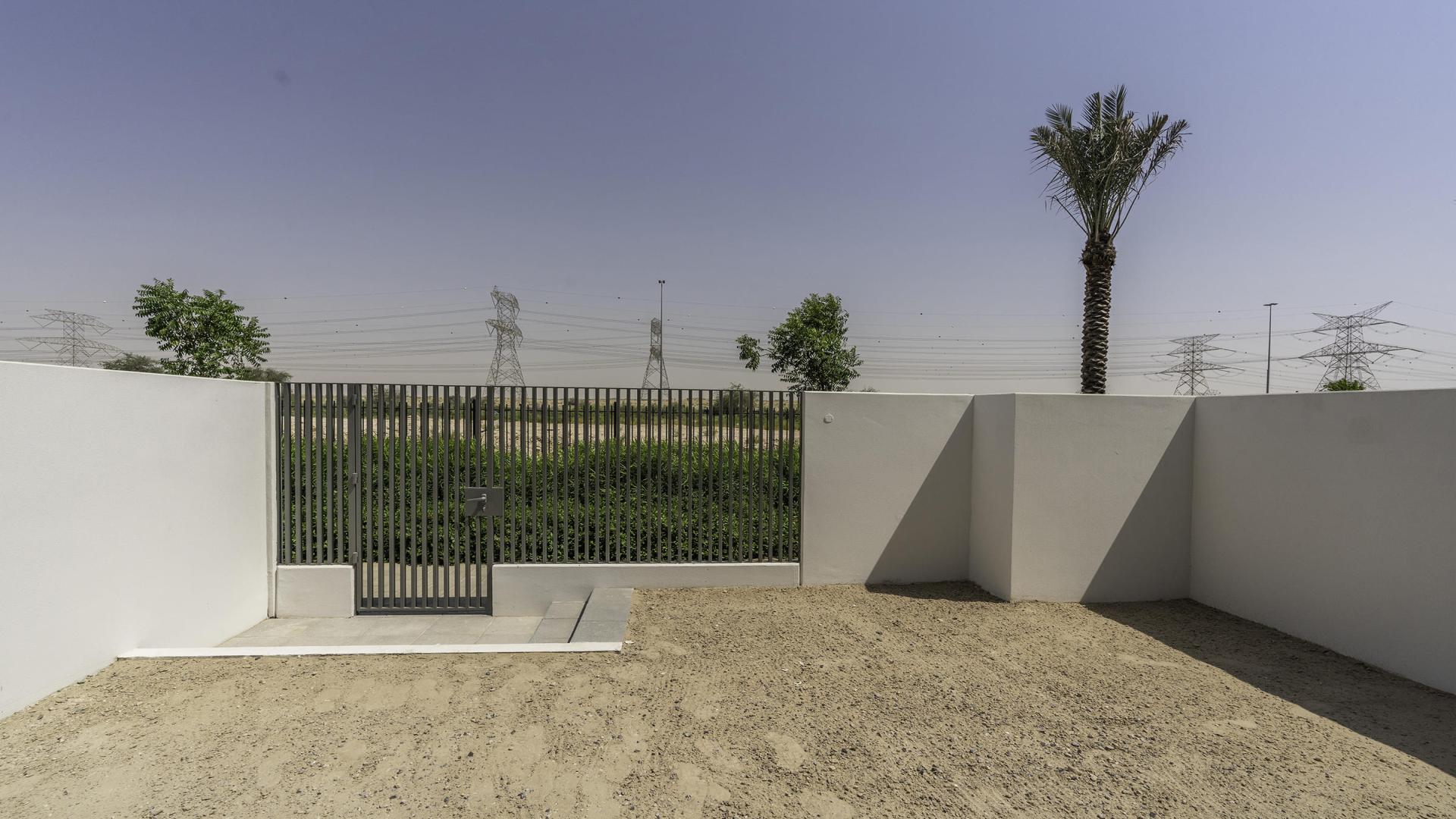 "Modern kitchen and staircase in Arabian Ranches 3 Ruba townhouse for rent, LP42185.",Exterior view of townhouse garden area in Ruba, Arabian Ranches 3 for rent