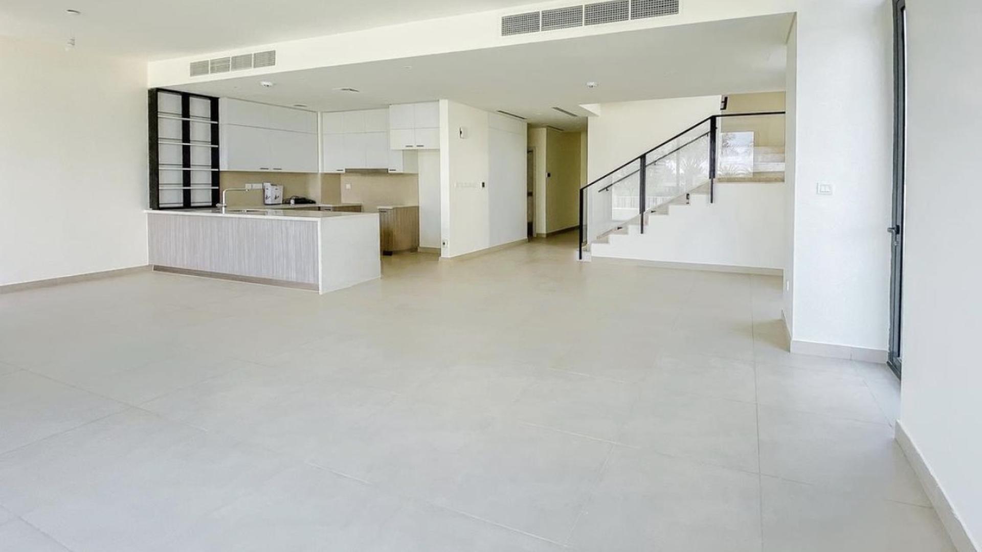 Modern townhouse exterior with patio in Club Villas, Dubai Hills Estate, available for rent