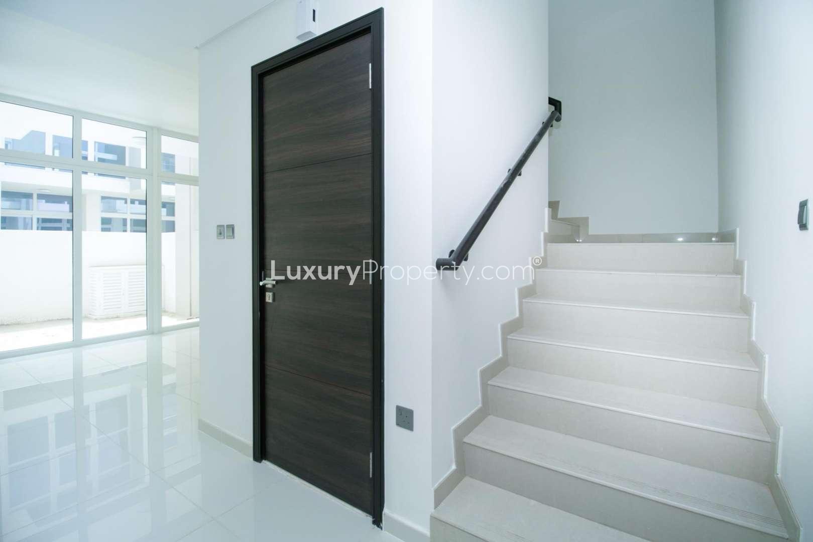 Bright living area with large windows in Akoya Oxygen townhouse, Vardon community