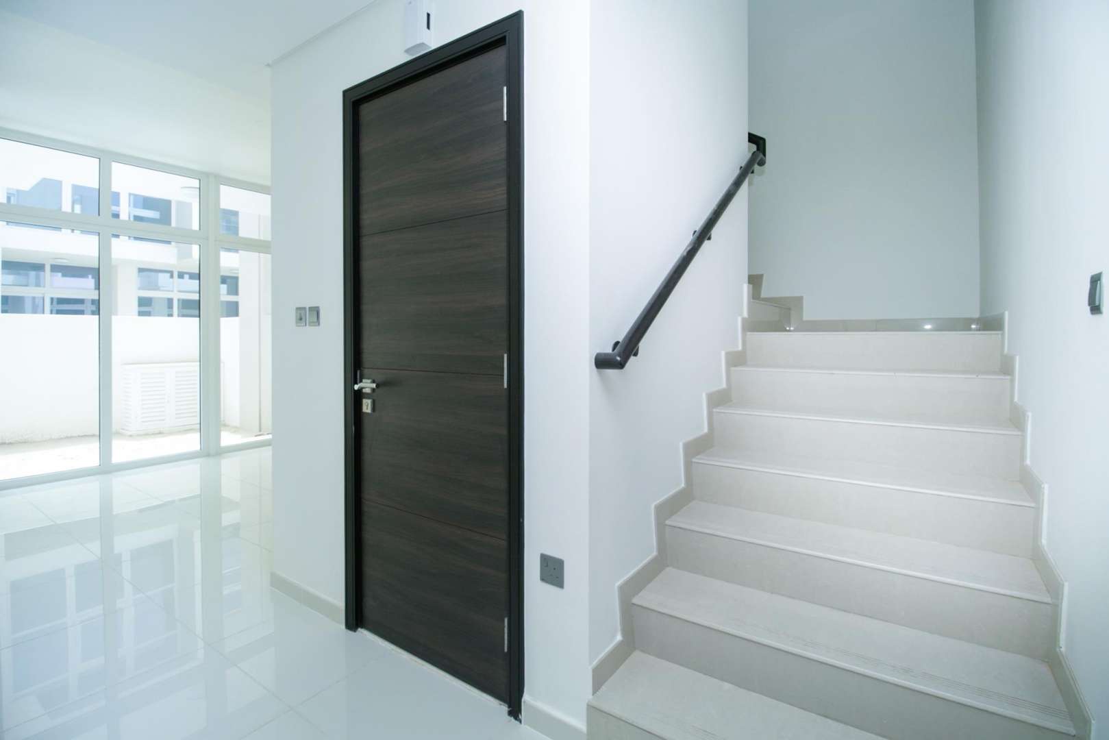 Bright living area with large windows in Akoya Oxygen townhouse, Vardon community