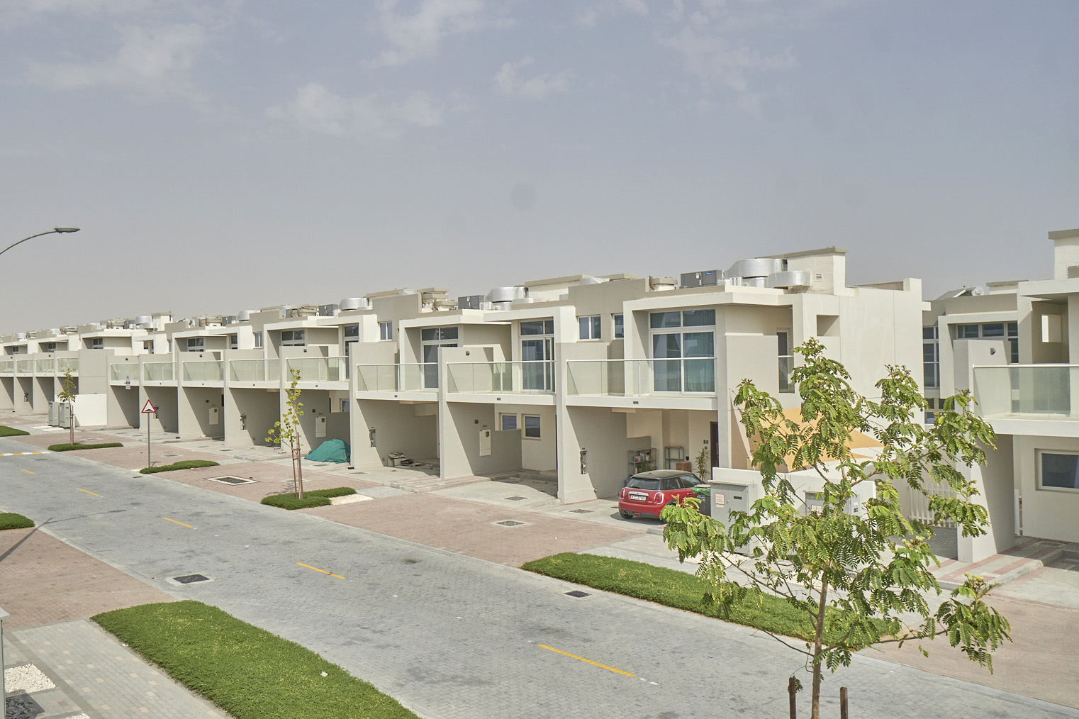 Three-bedroom townhouse exterior in Damac Hills 2, Albizia, with private garden and parking