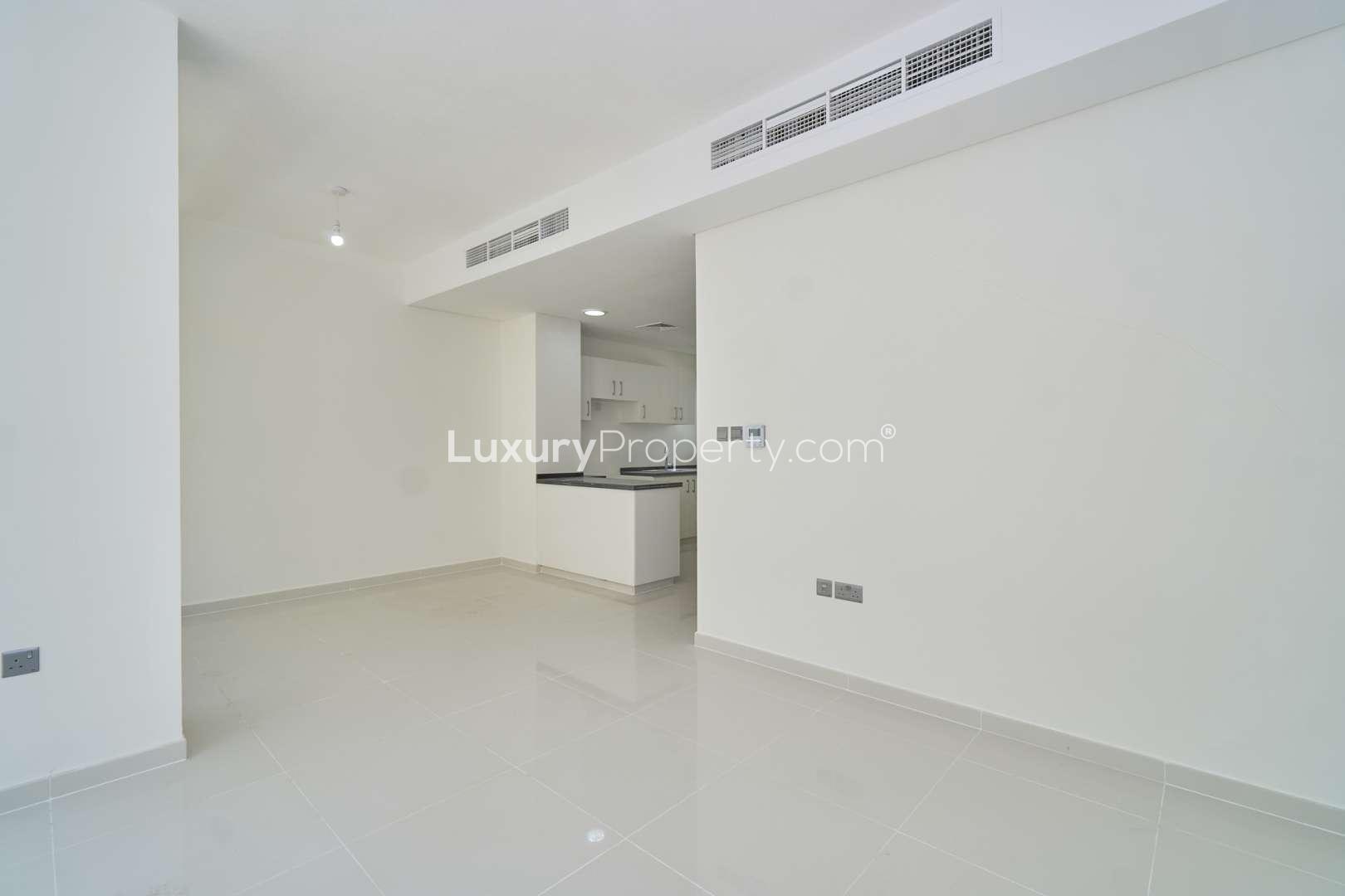 Modern kitchen and entrance in 3-bedroom townhouse for rent, Albizia, Damac Hills 2