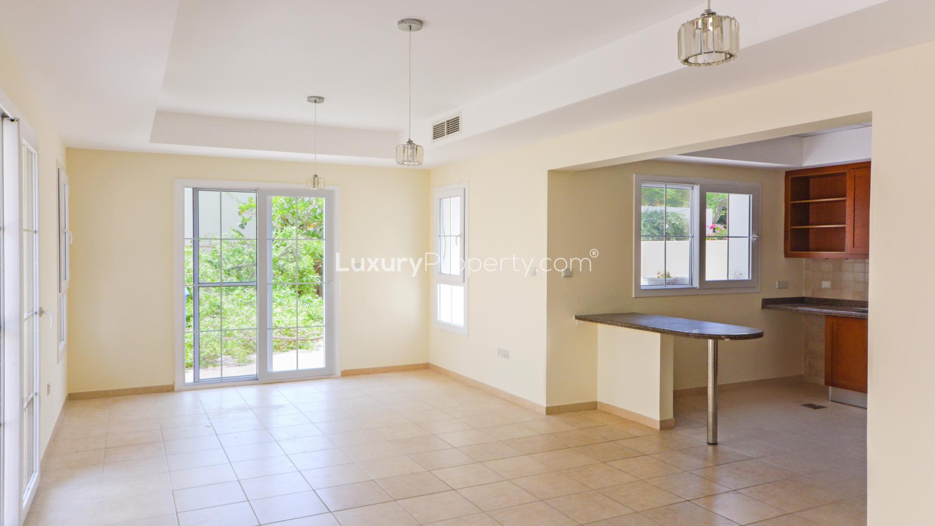 Front view of a townhouse with two-car garage in Arabian Ranches, Alma community