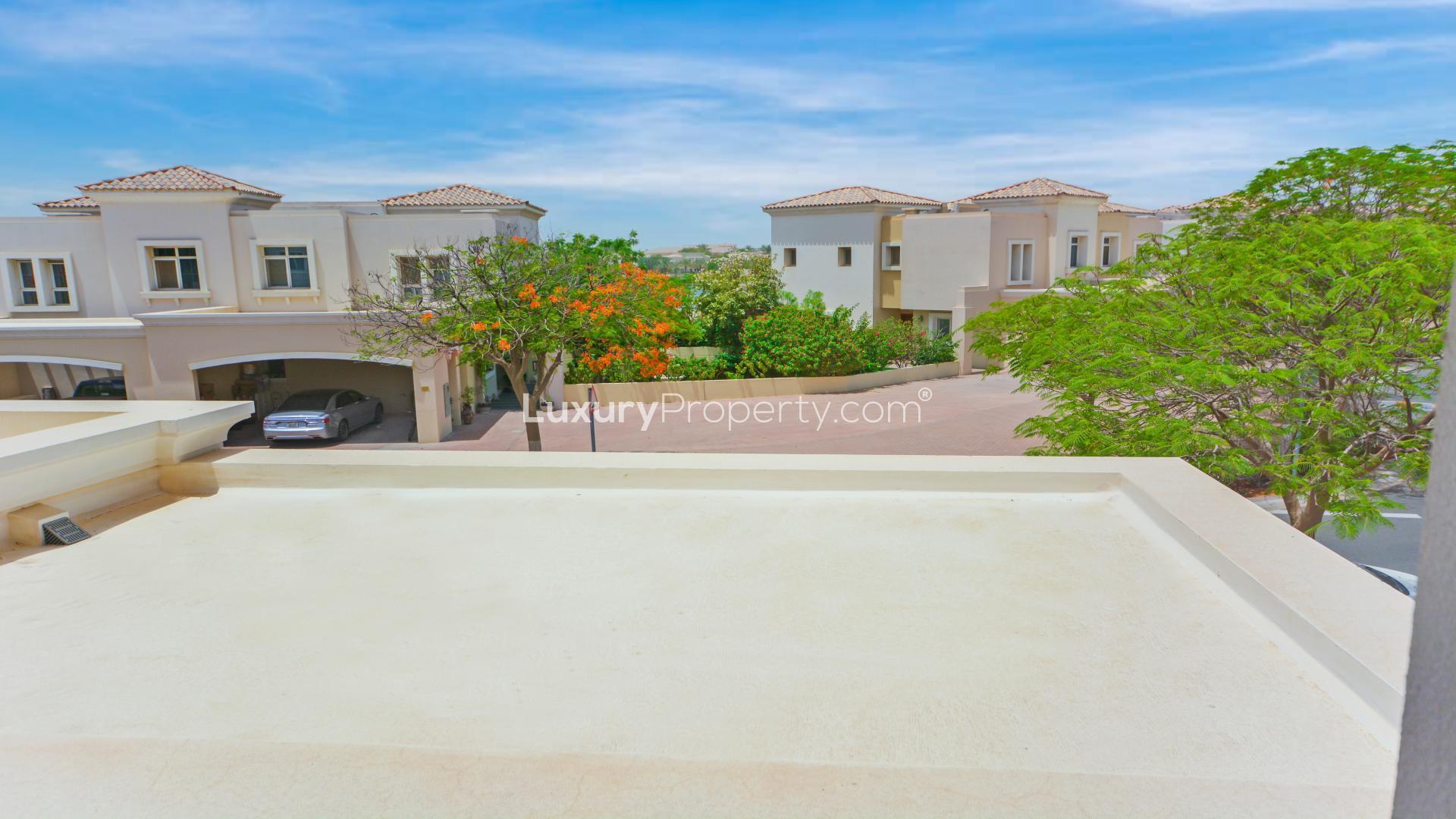 "Spacious living area in Alma townhouse, Arabian Ranches, with garden view and modern decor.","Charming townhouse in Arabian Ranches' Alma community with lush greenery and serene surroundings.",Bright living area in Arabian Ranches townhouse for rent, featuring large windows and tile flooring