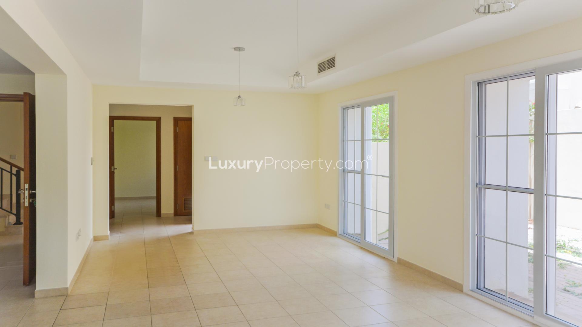 Modern kitchen in Arabian Ranches Alma townhouse for rent, featuring wooden cabinets and countertops