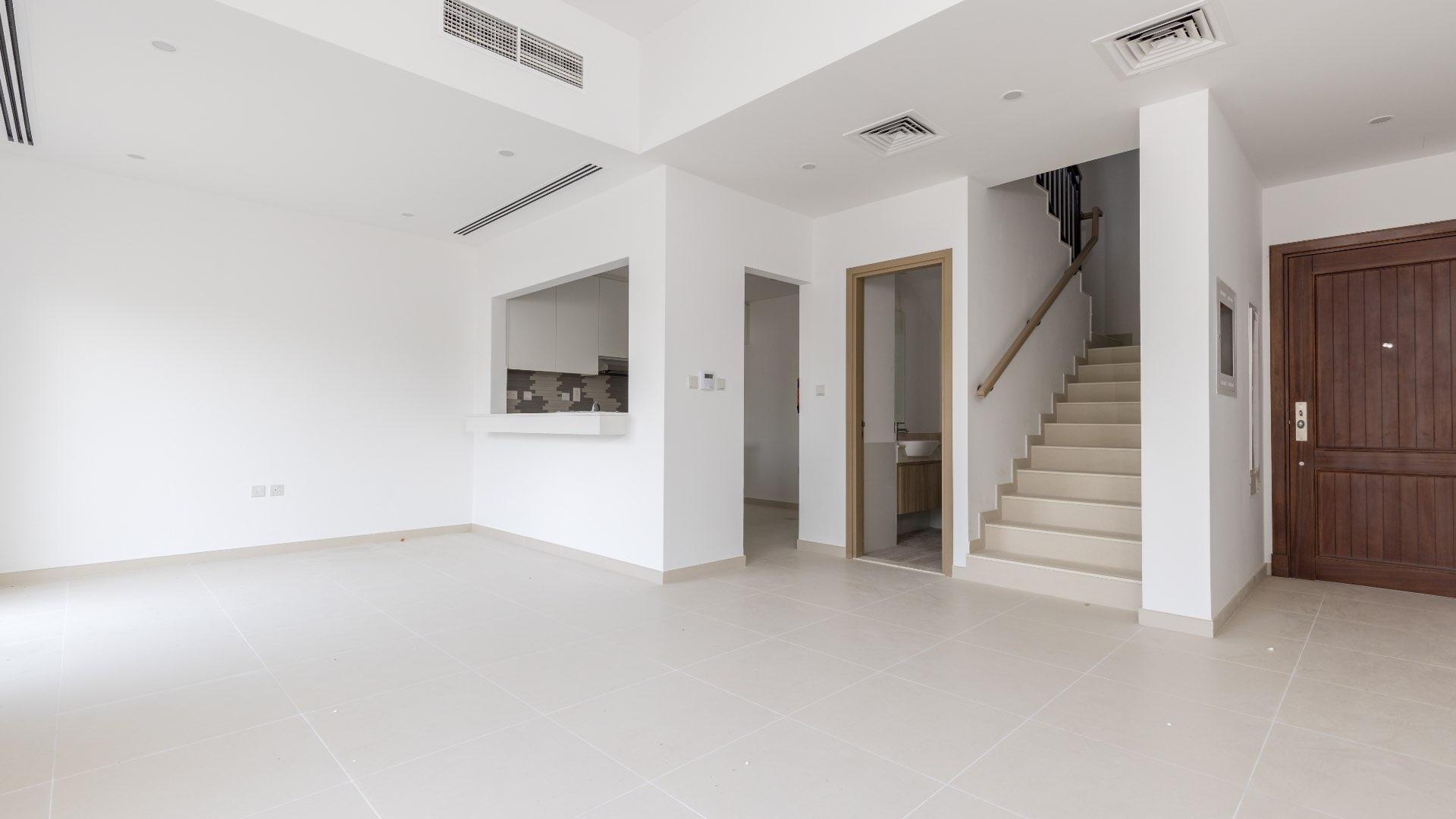 Modern living room with sliding doors, open kitchen in Villanova townhouse, Dubai Land