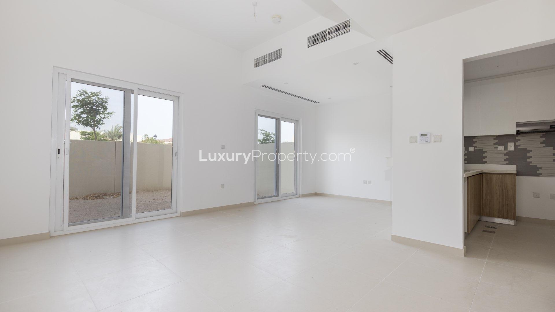 Modern townhouse exterior in Villanova, Dubai Land, with spacious parking area