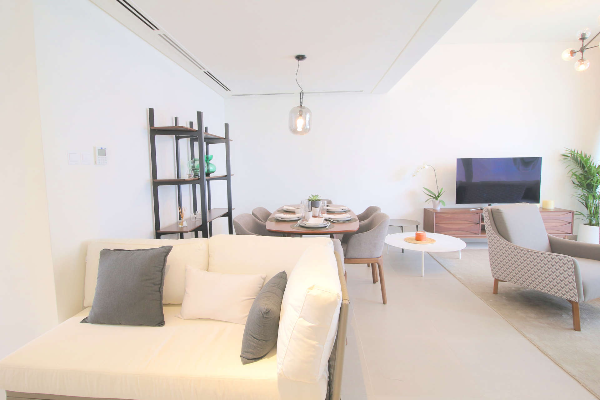 Modern living room and dining area in Arabella 2 townhouse, Mudon. Bright and spacious