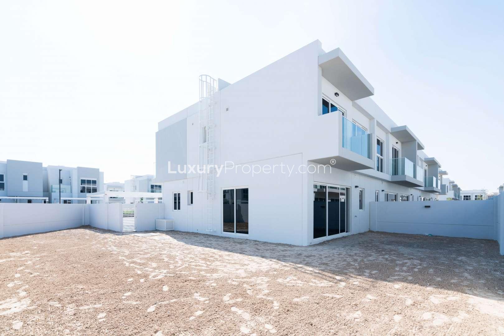 End unit townhouse with balcony in Arabella 3, Mudon, featuring modern design and landscaping