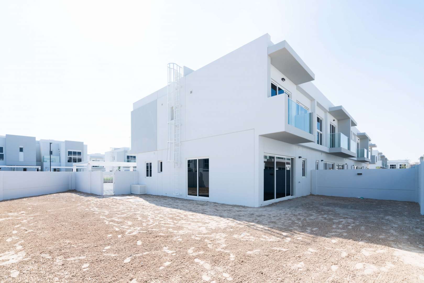 End unit townhouse with balcony in Arabella 3, Mudon, featuring modern design and landscaping