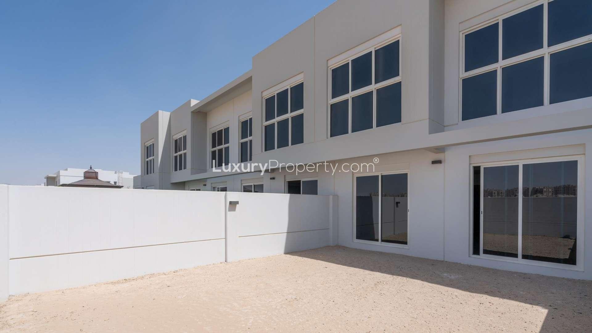 Open-plan living area in Type B townhouse, Arabella, Mudon, with staircase and kitchen view