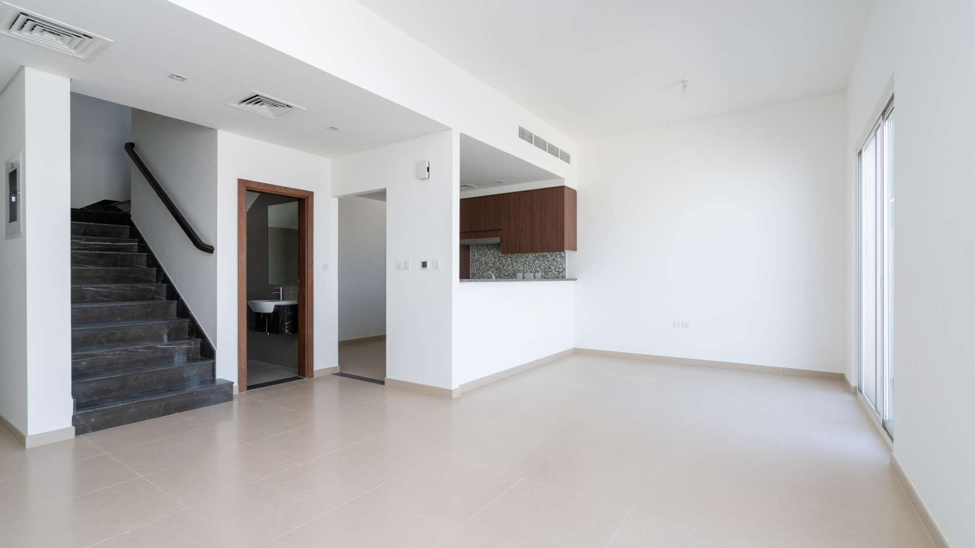 Charming three-bedroom townhouse exterior in Arabella, Mudon, featuring modern design and carport