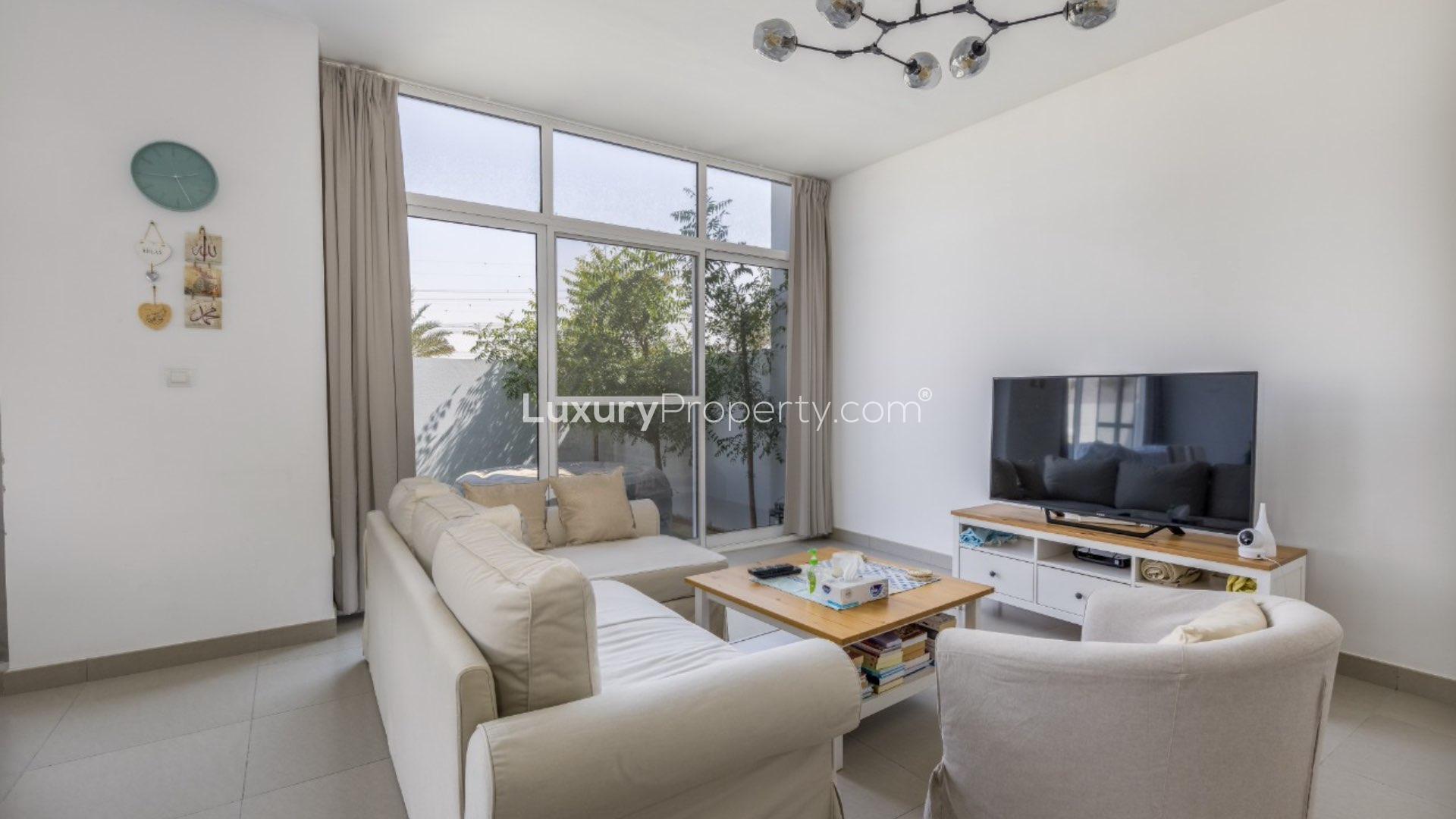 Spacious living area in 3-bedroom townhouse, Arabella, Mudon, with modern furnishings and garden view