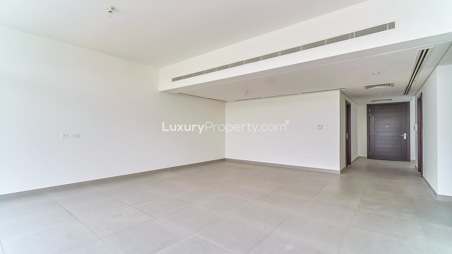 Spacious living room with large windows in Arabella townhouse, Mudon community