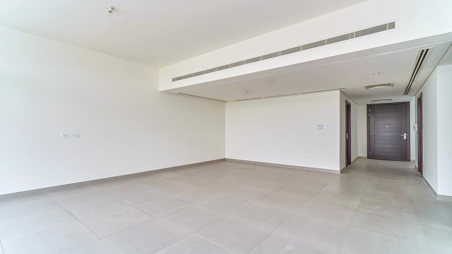 Spacious living room with large windows in Arabella townhouse, Mudon community