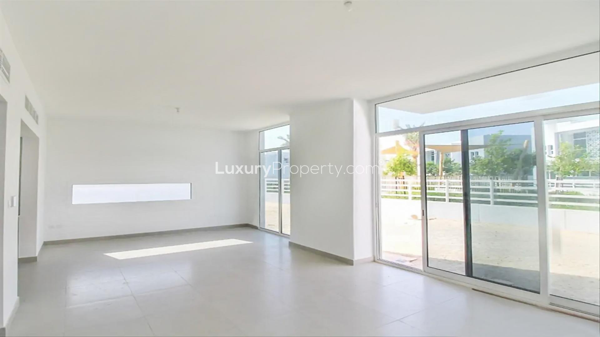 Luxurious Arabella 2 townhouse exterior with spacious lawn in Mudon community for rent