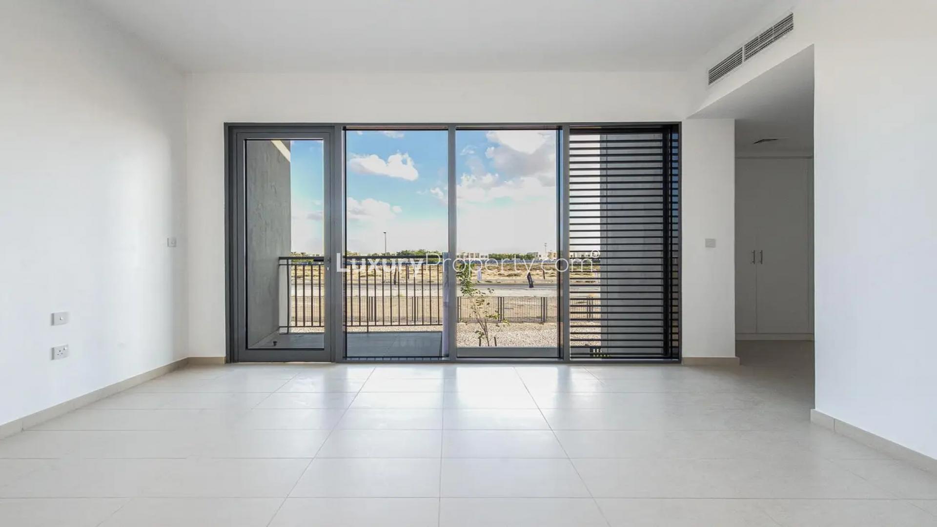 Bright kitchen and dining area in Cherrywoods townhouse, Dubai Land, with large windows