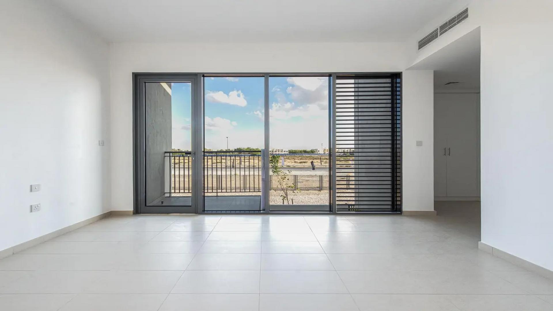 Bright kitchen and dining area in Cherrywoods townhouse, Dubai Land, with large windows