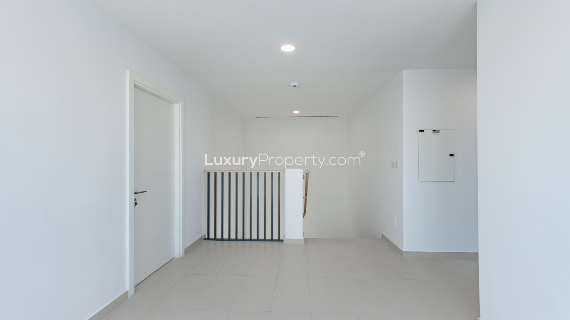 Spacious living area in Cherrywoods townhouse, Dubai Land, with large windows and modern design