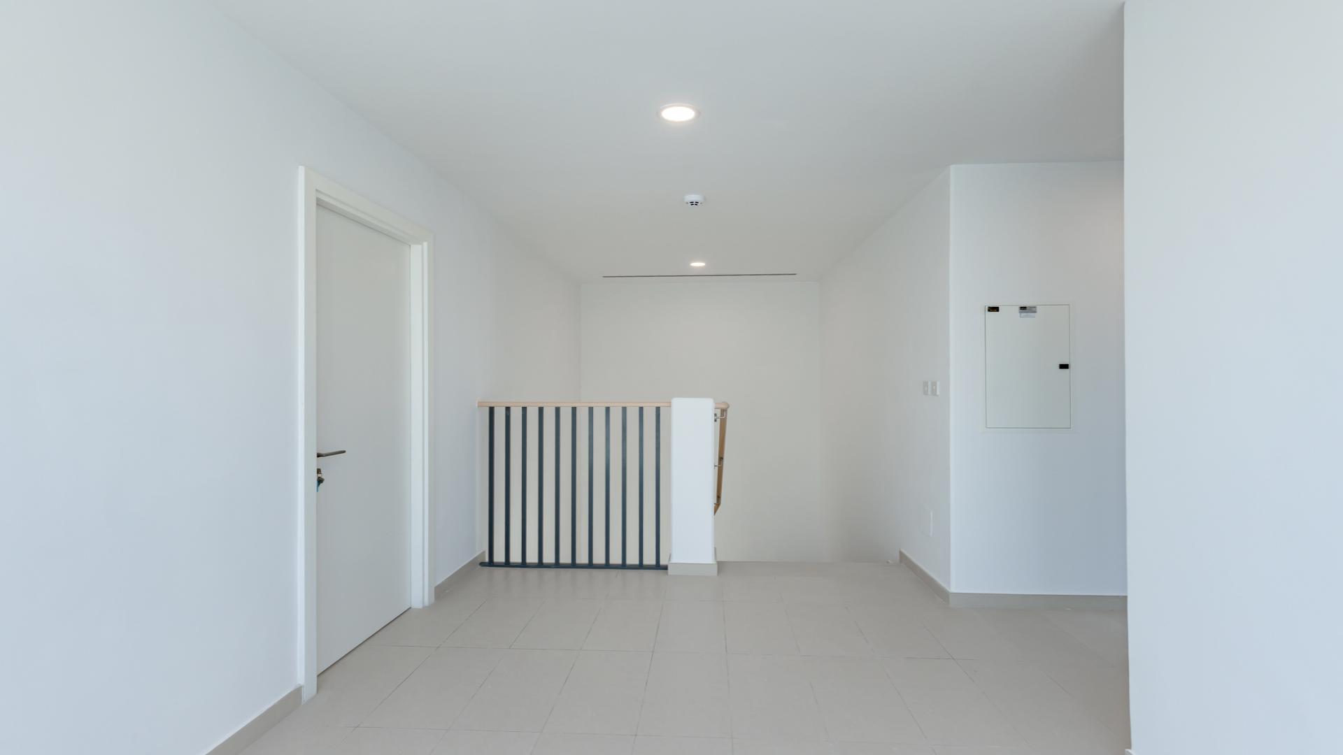 Spacious living area in Cherrywoods townhouse, Dubai Land, with large windows and modern design