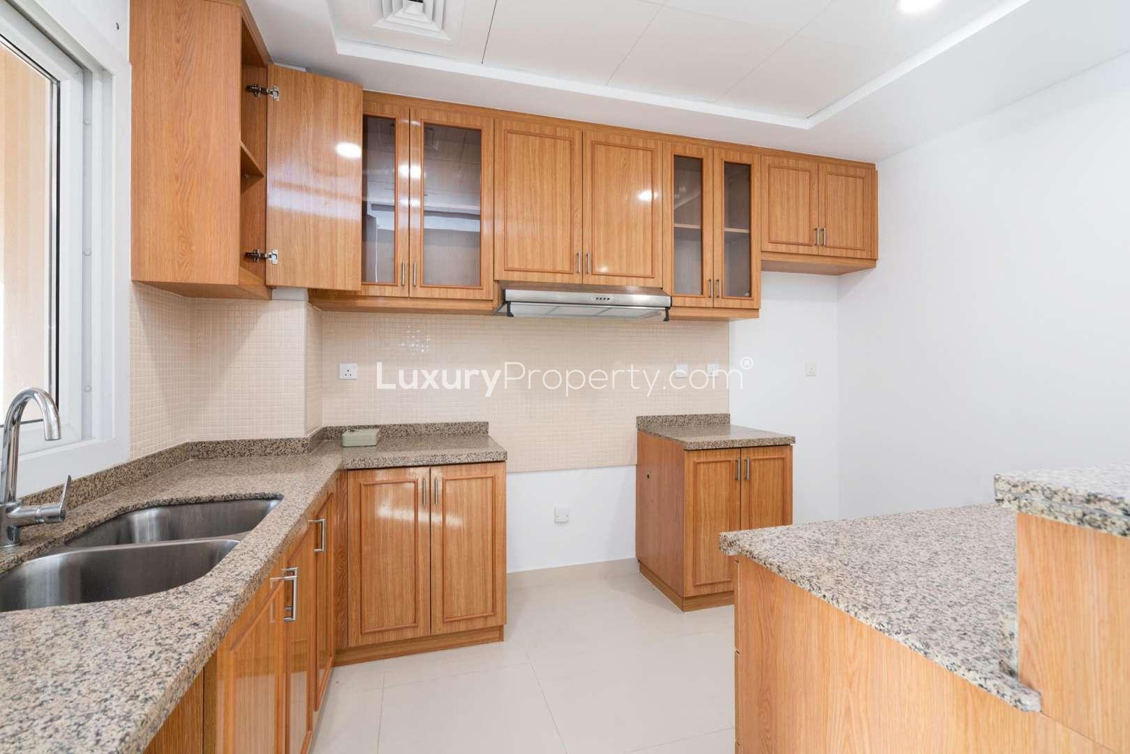 Spacious living area with open kitchen in Serena Bella Casa townhouse for rent
