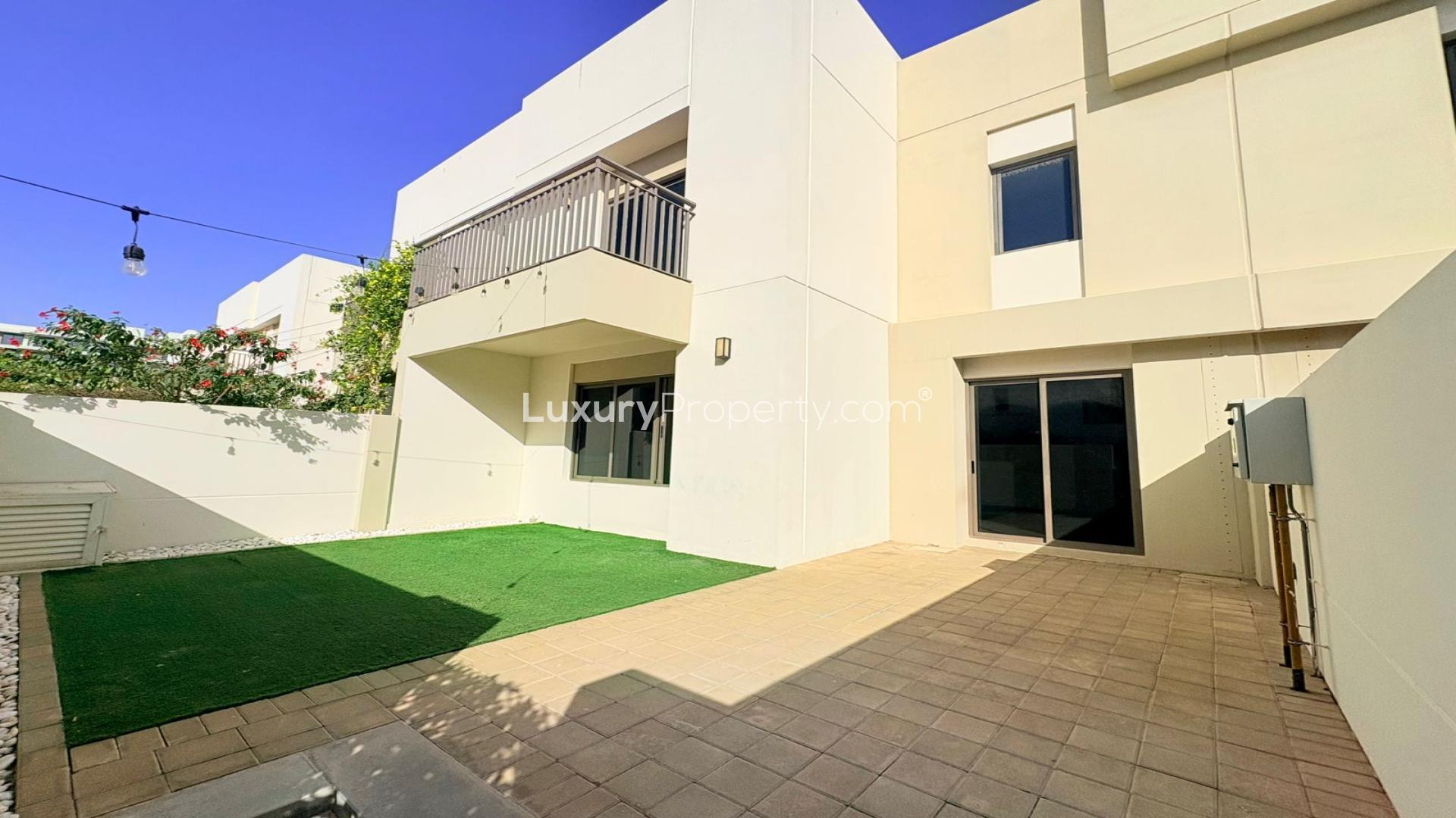 Sunny backyard view of Noor Townhouses in Town Square for rent