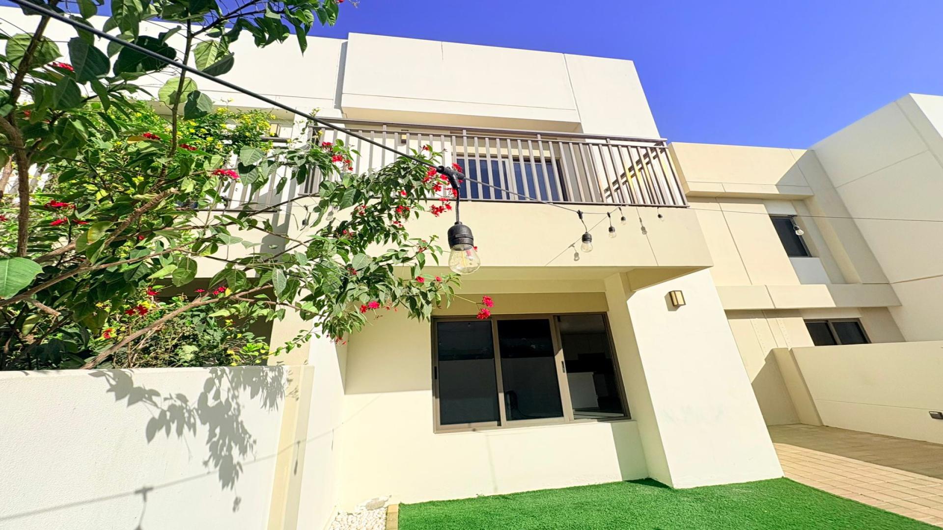 Townhouse courtyard with artificial grass and patio in Noor Townhouses, Town Square