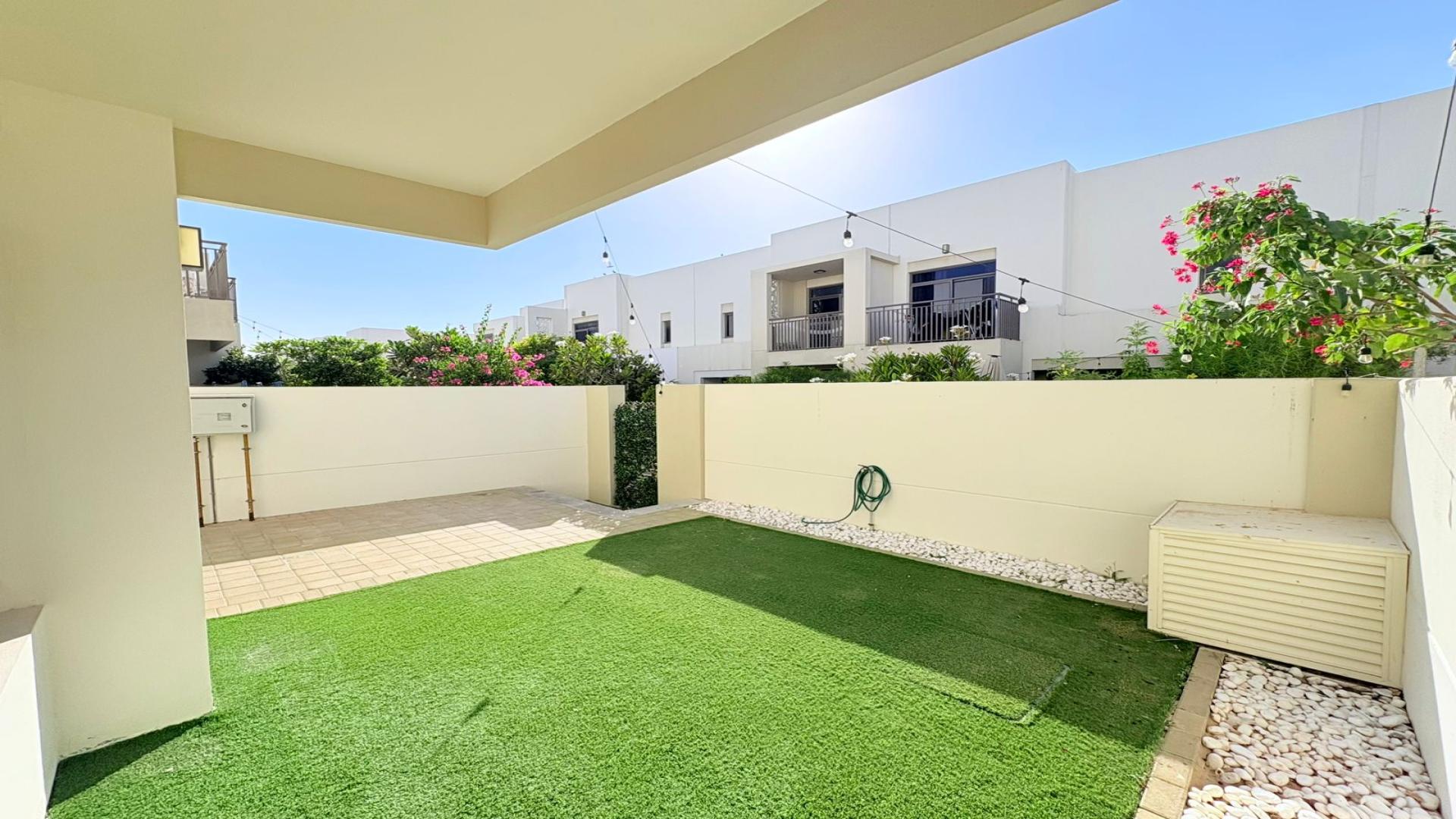 Bright open-plan kitchen and living area in Town Square Noor Townhouses for rent